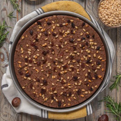 Una pietanza tipicamente toscana, rustica, a metà strada tra dolce e salato, a base di farina di castagne, uvetta e pinoli