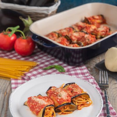 Spaghetti vvolti nelle fettine di melanzane ripassati in teglia