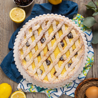 La crostata amalfitana è un dolce che unisce alcune delle preparazioni base della pasticceria, come pasta frolla e crema pasticcera, con in più il tocco delle amarene sciroppate