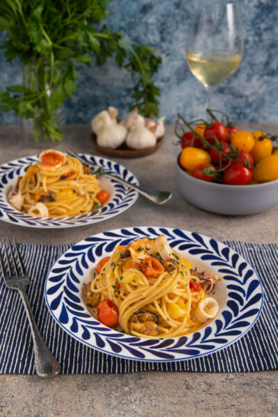 Gli spaghetti allo scoglio sono un primo piatto di pesce che include gamberi, calamari, cozze, vongole e pomodorini che ti farà sentire subito in piaggia