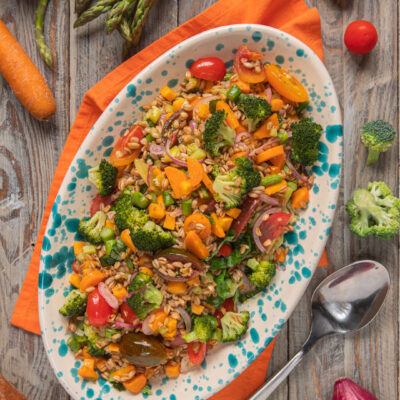 Farro, patate, cipolle, broccoli, aspargina, carote, pomodorini ed erbe aromatiche: il risultato è un'insalata leggera ma coloratissima e ricca di gusto